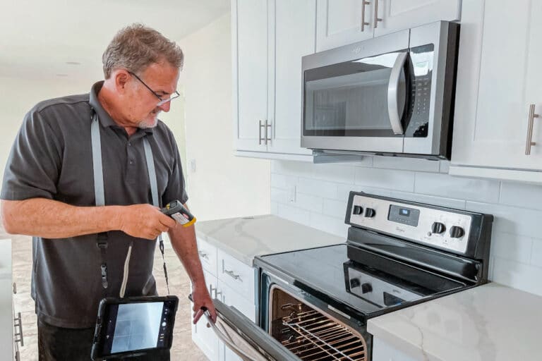 home inspector inspecting the oven with a temperature gauge