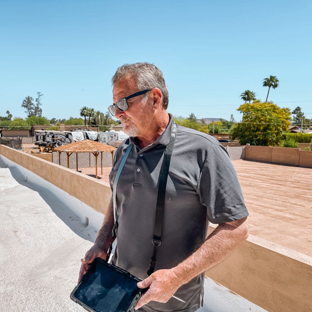 home inspector jeff hunter inspecting a roof top