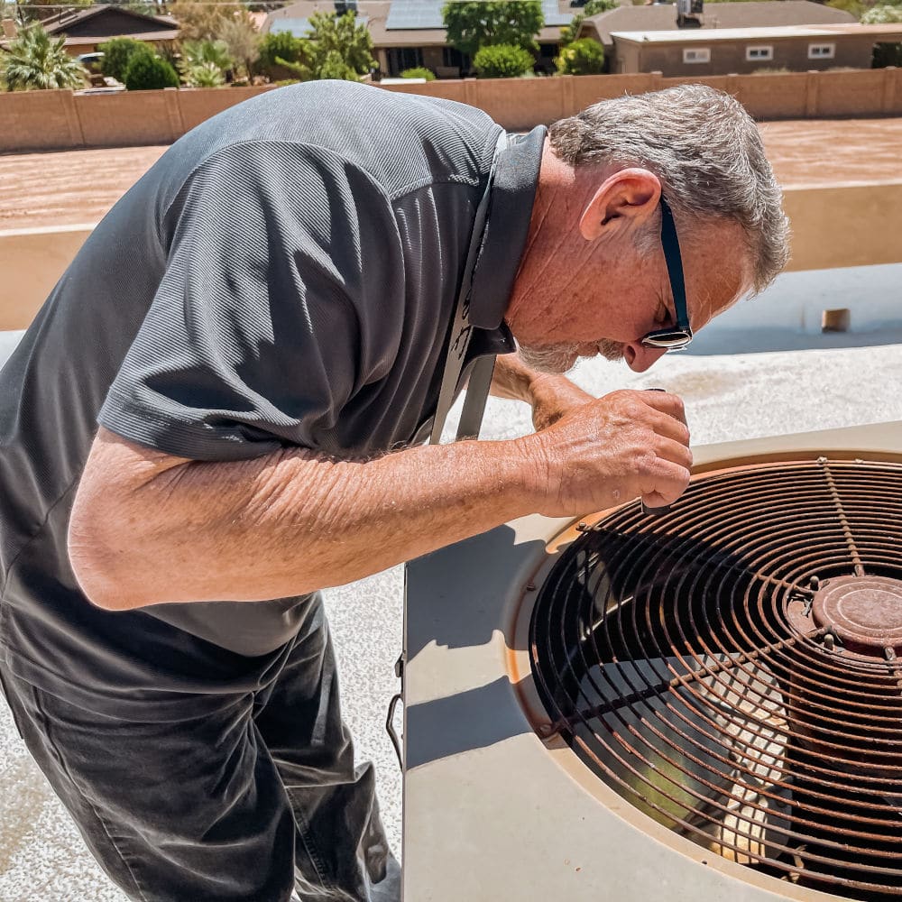 Jeff Hunter, the home inspection company owner inspecting an HVAC unit.